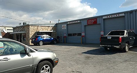 A car parked in front of a garage.