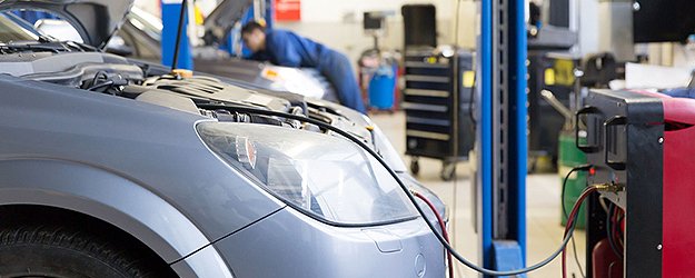 A car is being worked on in the shop.