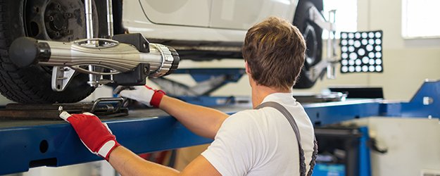 A man working on a car in a garage.